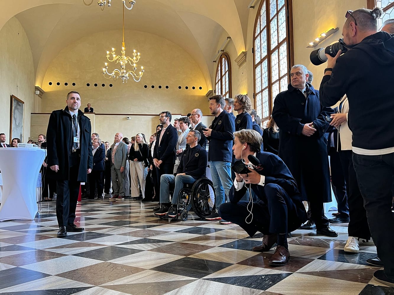 Distinguished guests and photographers watch presentation from the Czech Olympic Team featuring the Czech President