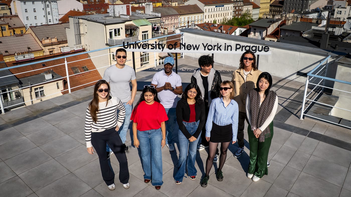 Students standing on a rooftop terrace overlooking Prague during a UNYP photoshoot.