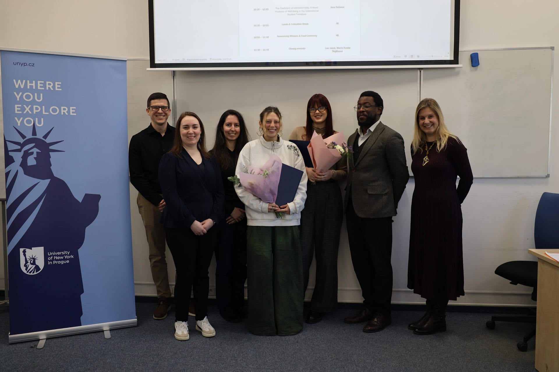Judges, student winners, and UNYP faculty pose for a photo after the psychology competition