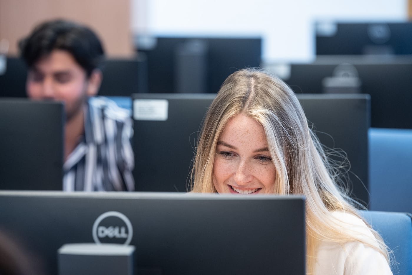 An IT student reviews some lines of code during a class on cyber security.