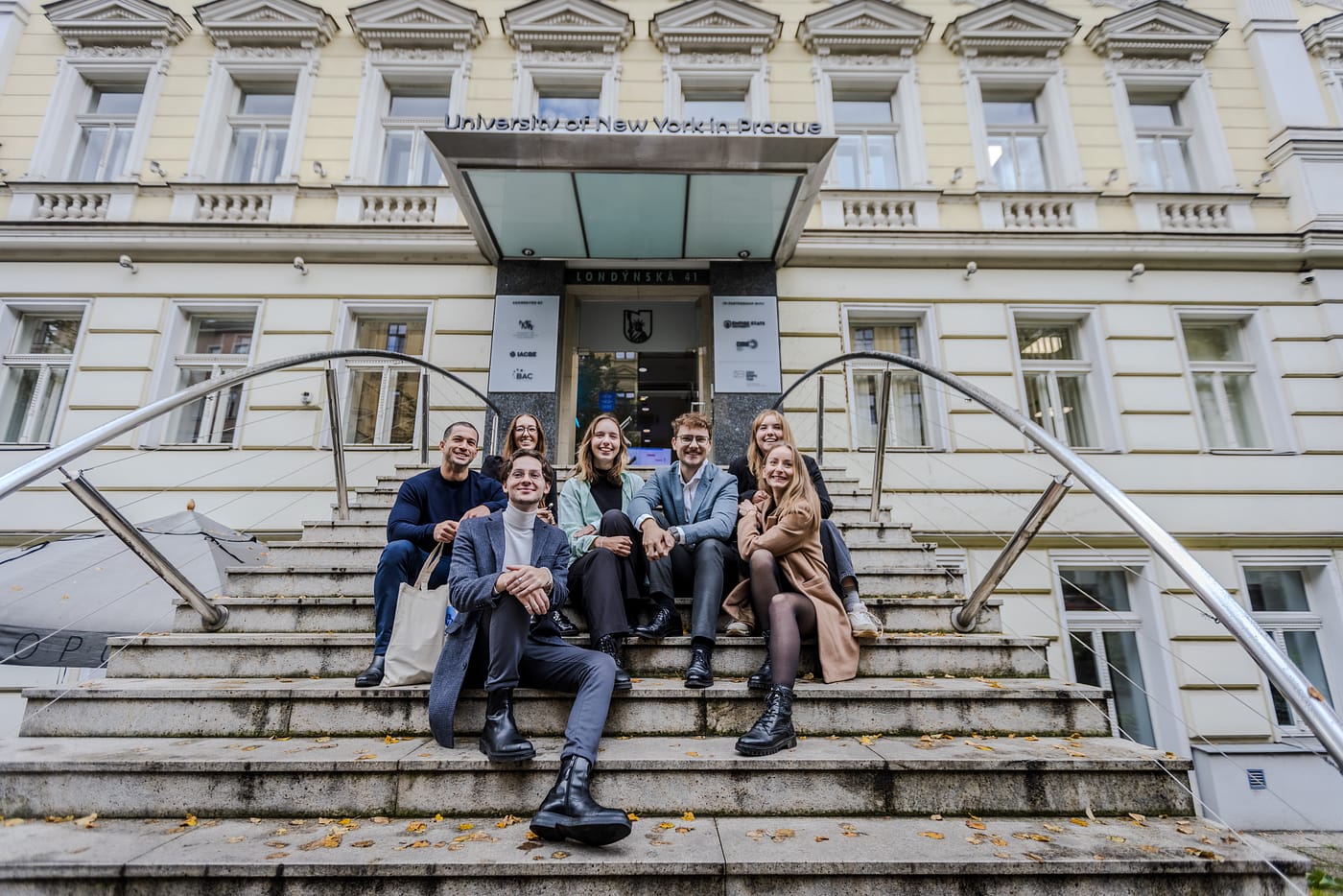UNYP students pose on the stairs of the main campus building.