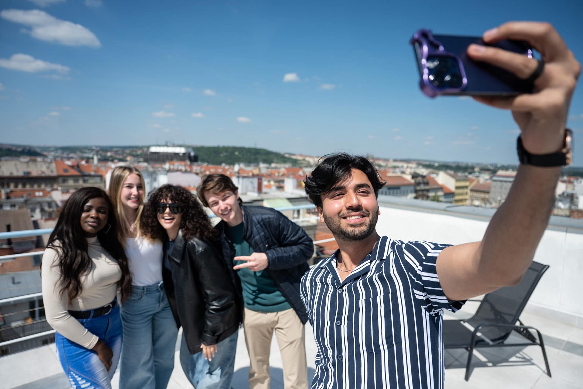 UNYP university students pose for a group selfie on the roof of the main campus building during orientation week