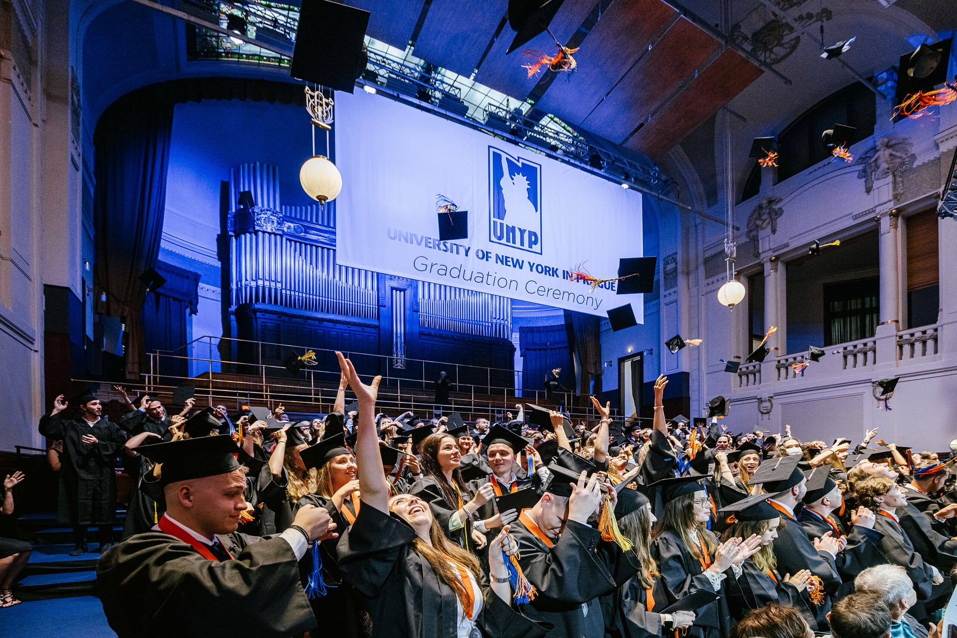 Students, families, and guests gathered in a Prague's Municipal House during a UNYP graduation ceremony.